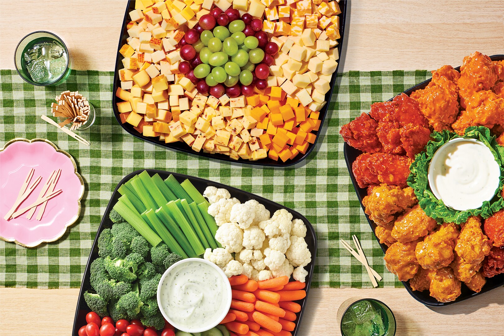 Variety of sub platters on a green checkerboard  table cloth