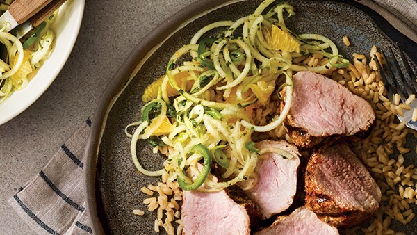 Spiced pork with citrus apple slaw and rice