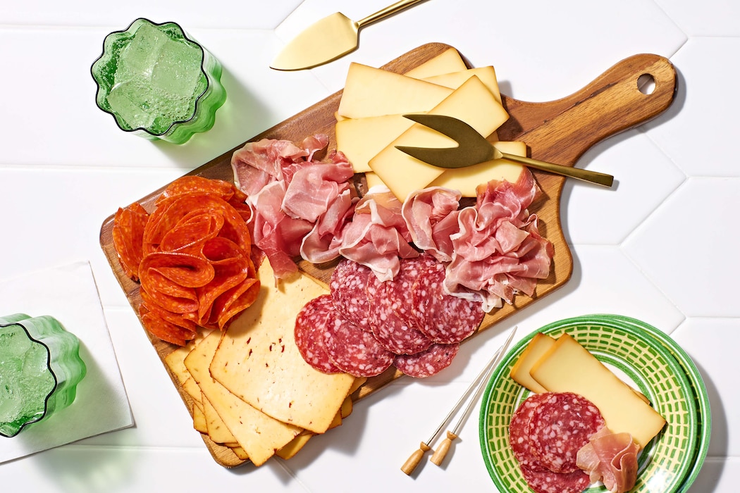 Charcuterie board with sliced meats and cheeses.