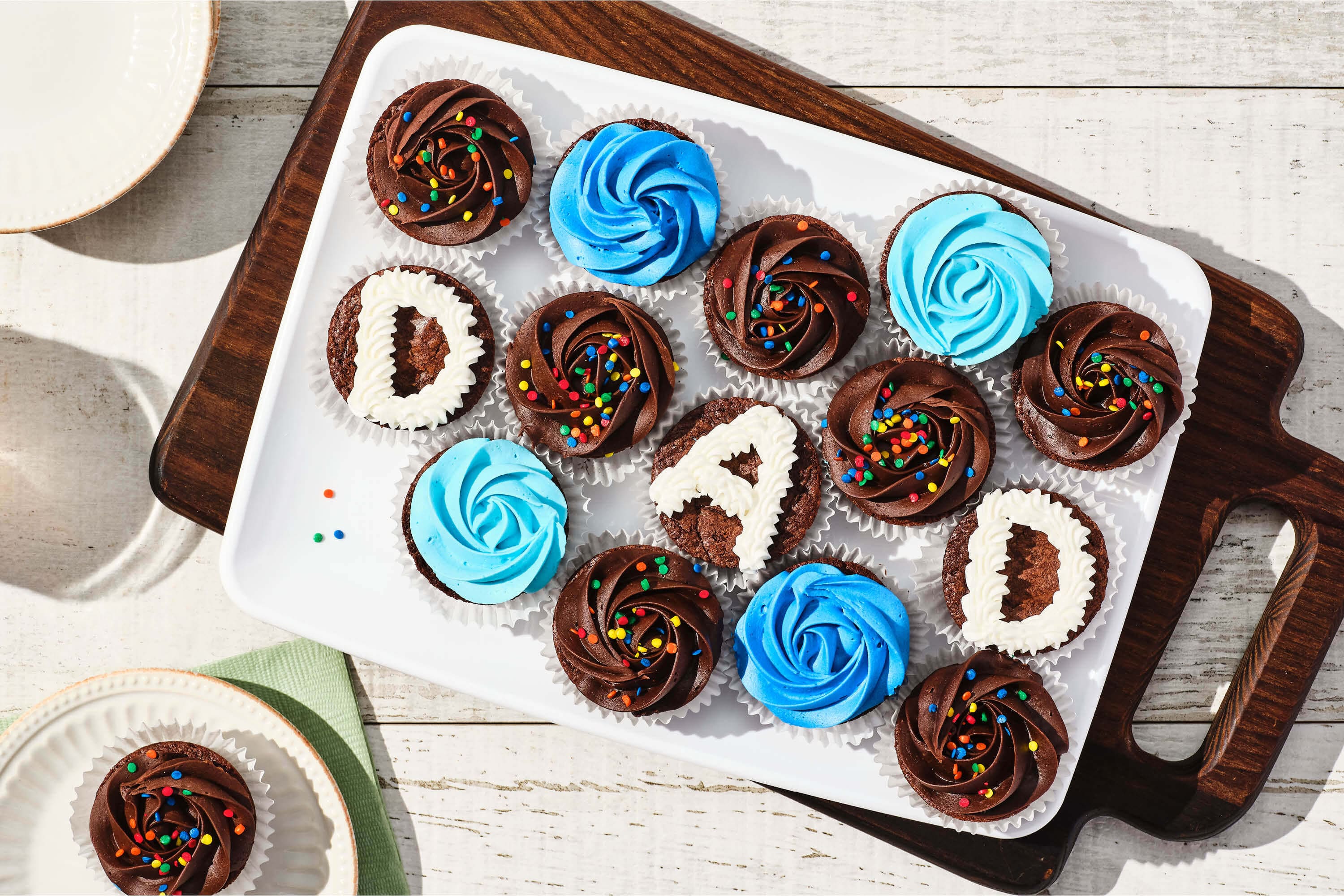A brownie bites platter with blue icing, chocolate icing, and “Dad” spelled out on three brownies.