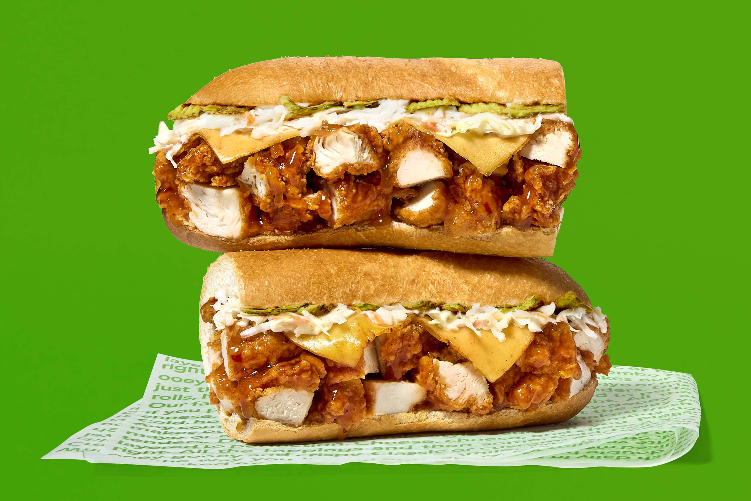 Two halves of the new Sweet Peach Heat Chicken Tender Sub, one stacked on top of the other.