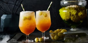 two cocktails with olives