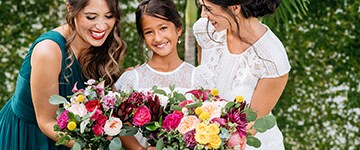 bride, bridesmaid, and flower girl smiling