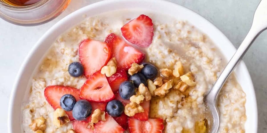 bowl of oatmeal with fruits and nuts