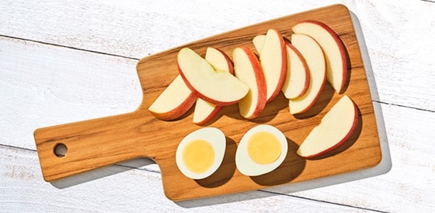 cutting board with raw apples