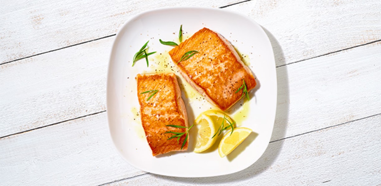 Fresh cooked salmon and lemon on a plate