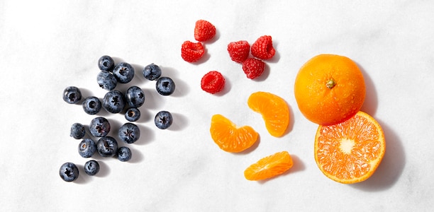 Fresh blueberries, raspberries, and oranges 
