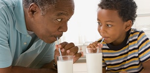 man and boy drinking milk