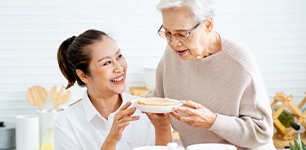 woman and man sharing a plate of food 