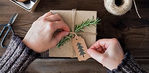 hands wrapping Christmas gift