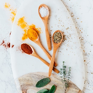 wooden spoons filled with various spices