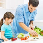 father and daughter cooking