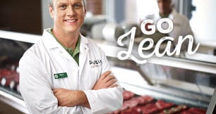 Meat Clerk standing in front of meat case