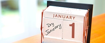 Desk calendar on January 1st with "Dry January" written on it. 