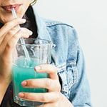 woman drinking green smoothie