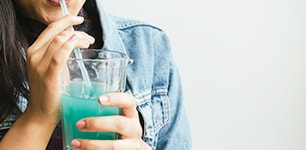 woman drinking green smoothie