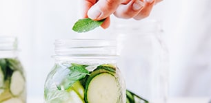 jar of cucumber slices and mint leaves