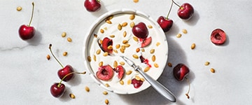bowl of yogurt with fresh cherries 