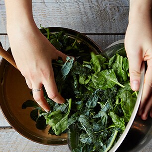 hands grabbing spinach