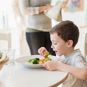 Boy eating veggies