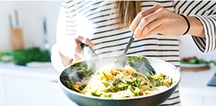 woman standing with fry pan