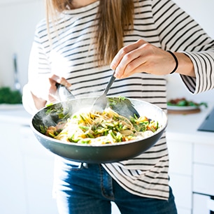 woman holding frying pan