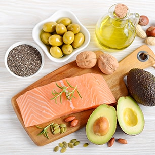 display of raw salmon, avocado, olives, nuts and olive oil