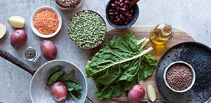 raw vegetables and bowls of beans