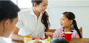 Mother and children at dinner table