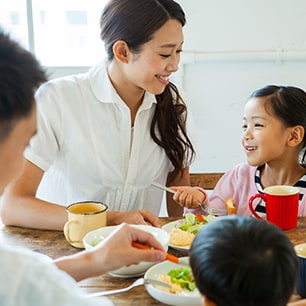 Mother and children at dinner table