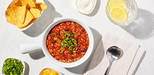 bowl of ancho turkey and farro chili with chips