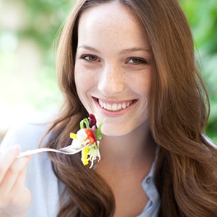 Woman eating a salad.