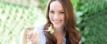 Woman eating a salad.