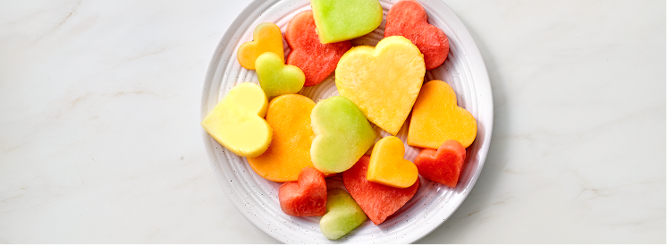 fruit cut into the shape of hearts on a plate 