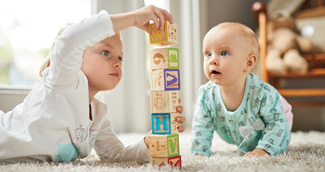 babies playing with blocks