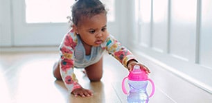 baby crawling to sippy cup