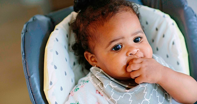baby eating in high chair