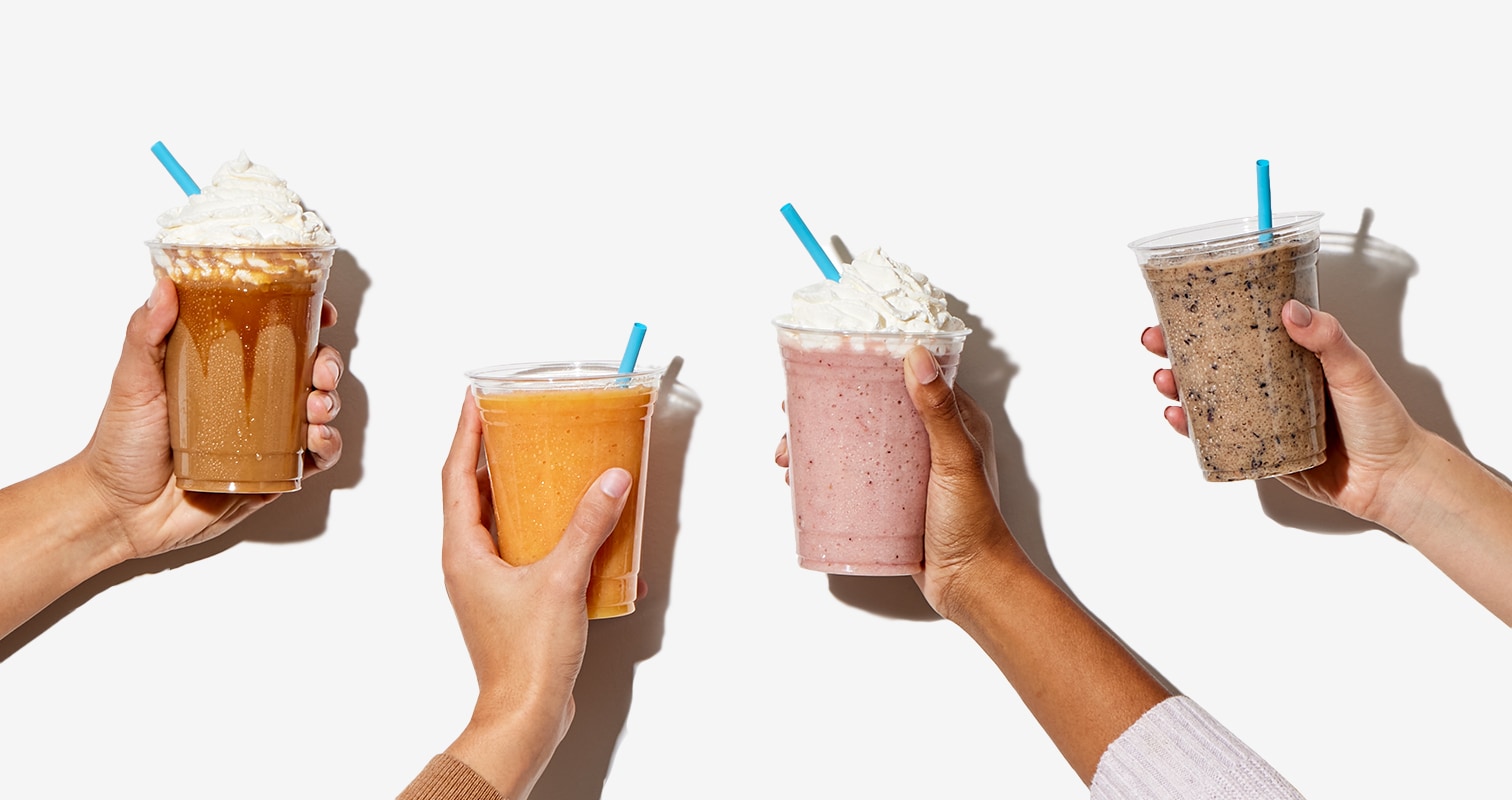 Salted Caramel Frozen Protein Latte, an Orange Pineapple Protein Smoothie, a Strawberry Shortcake Protein Shake, and a Blueberry Banana Protein Smoothie