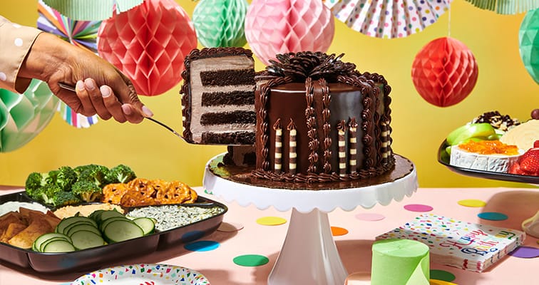 Chocolate Ganache Supreme Cake being sliced on a cake stand