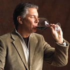 man sipping wine from a glass