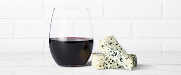 Glass of red wine paired with bleu cheese
