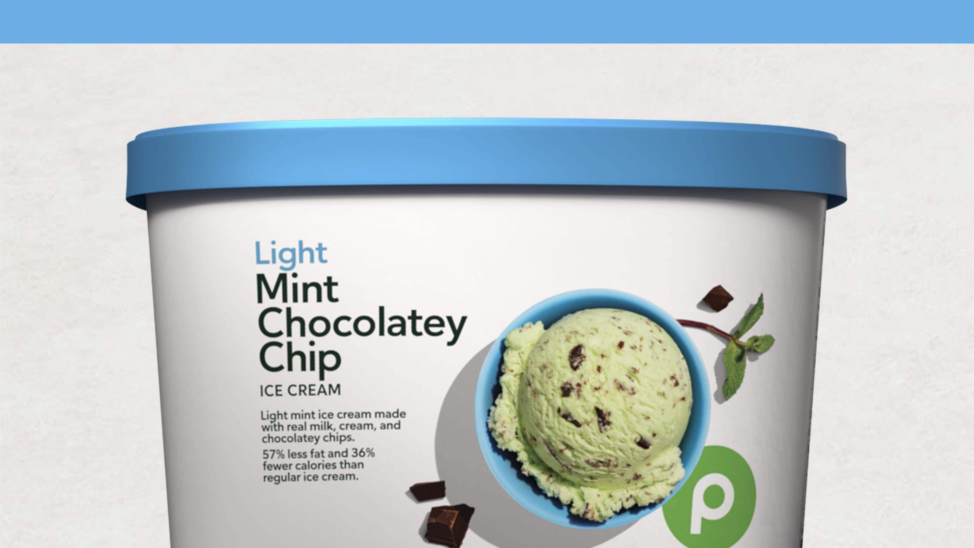 A tub of Publix Light Mint Chocolatey Chip ice cream with a blue lid, featuring a scoop of ice cream and mint leaves on the label.