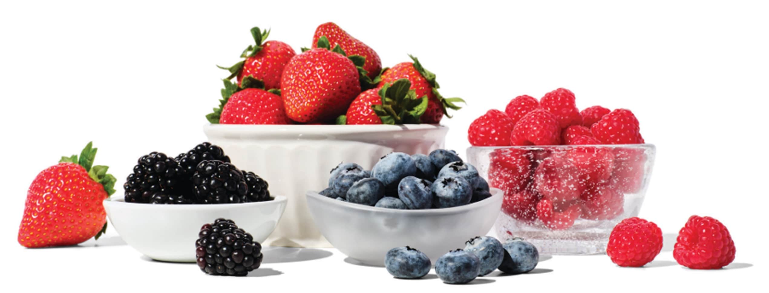 bowls of fresh strawberries, blueberries, blackberries, and raspberries 