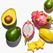 Florida-fresh tropical fruits including green avocados, passion fruit, carambola fruit, and dragon fruit.