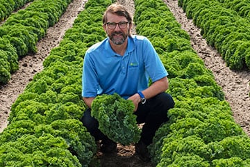 man holding fresh produce at a farm
