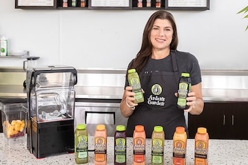 woman holding Arden Gardens juices 