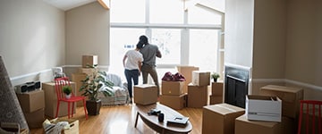 couple with packing boxes in new home 