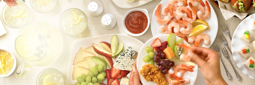 person holding plate at buffet table