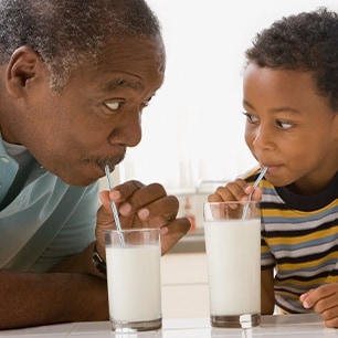 man and boy drinking milk