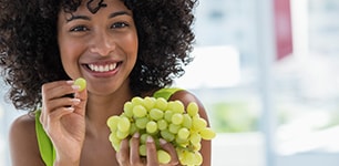 Woman holding green grapes